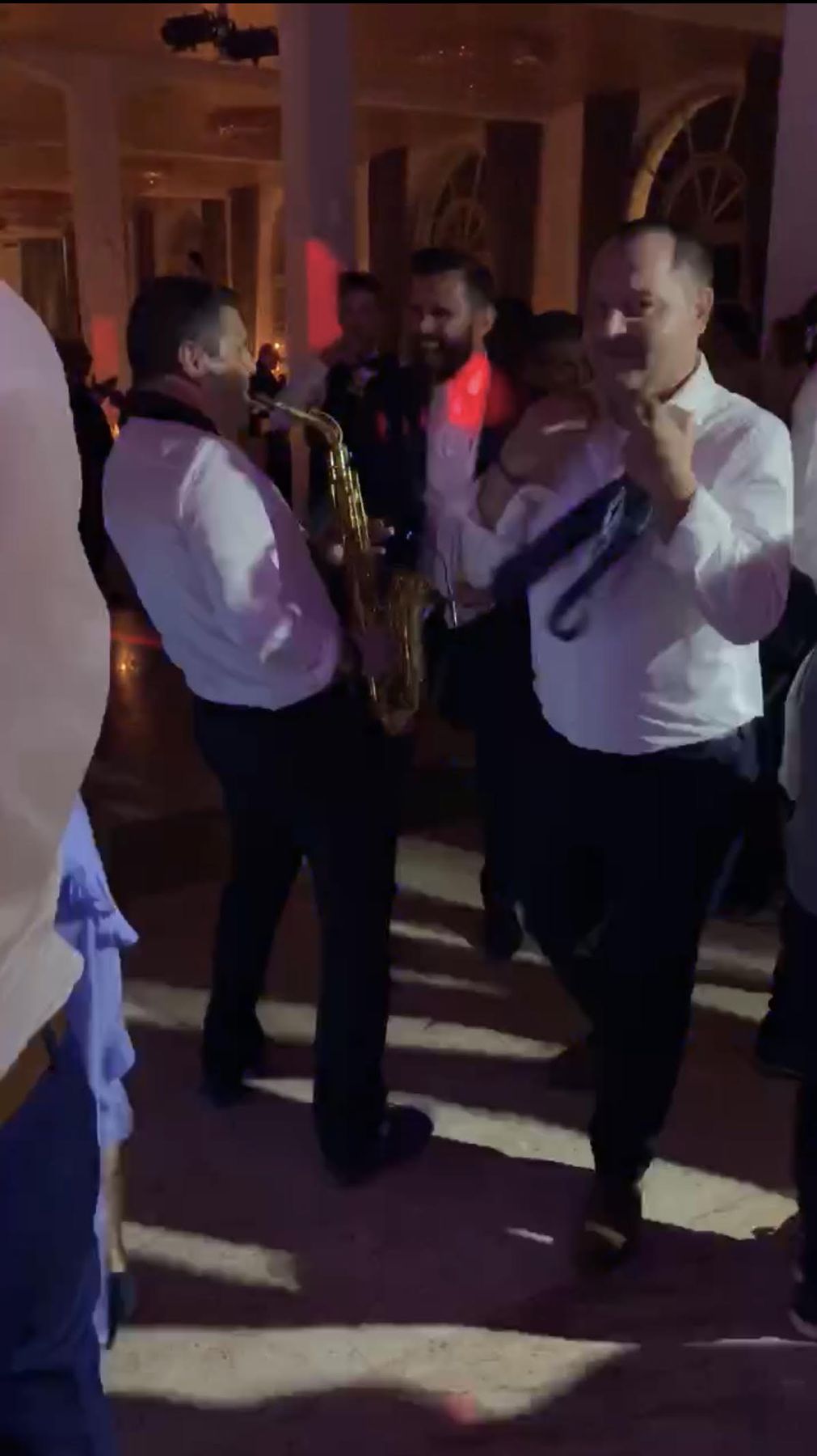 Saxophonist Vanja Ileković performing at an international destination wedding – ornate venue, party set, live sax moment